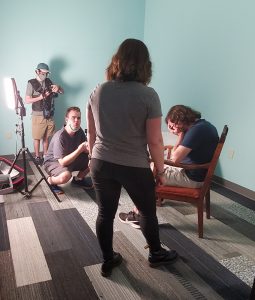 behind the scenes image of the making of Abuse: There is support video, includes actor, filmmaker, lighting and sound tech and director