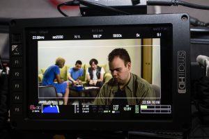 monitor showing a behind the scenes image of the making of Abuse: There is Support video